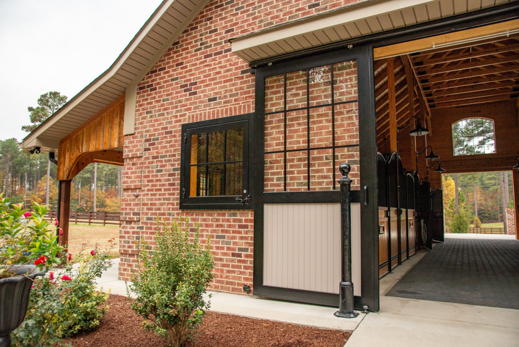 Closeup view of entrance to a brick horse barn